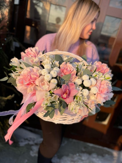 Woman holding a basket of pink flowers