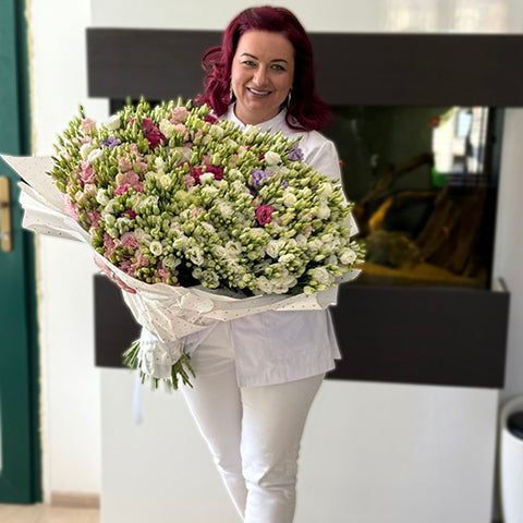 Woman holding a large bouquet of lisianthus