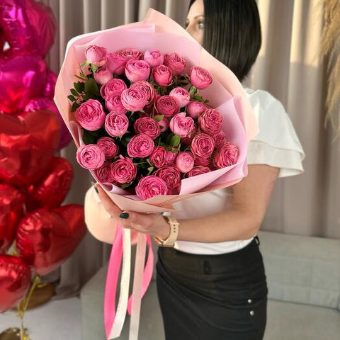 Woman holding a bouquet of pink roses