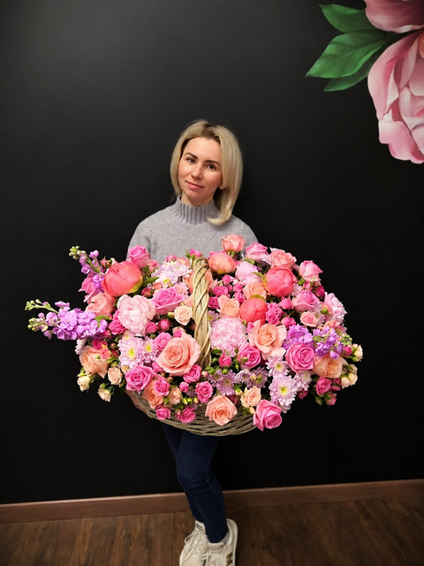 Woman holding a pink flower arrangement