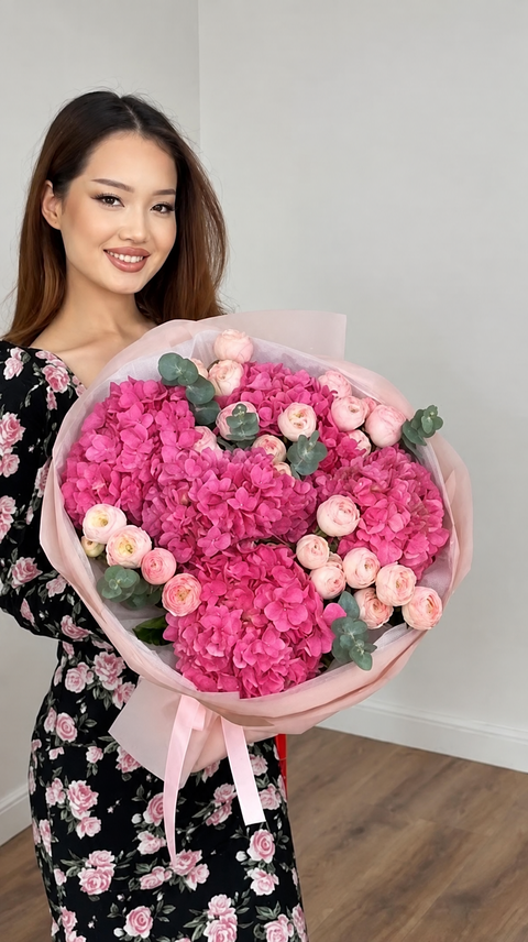 Woman holding a bouquet of pink hydrangeas